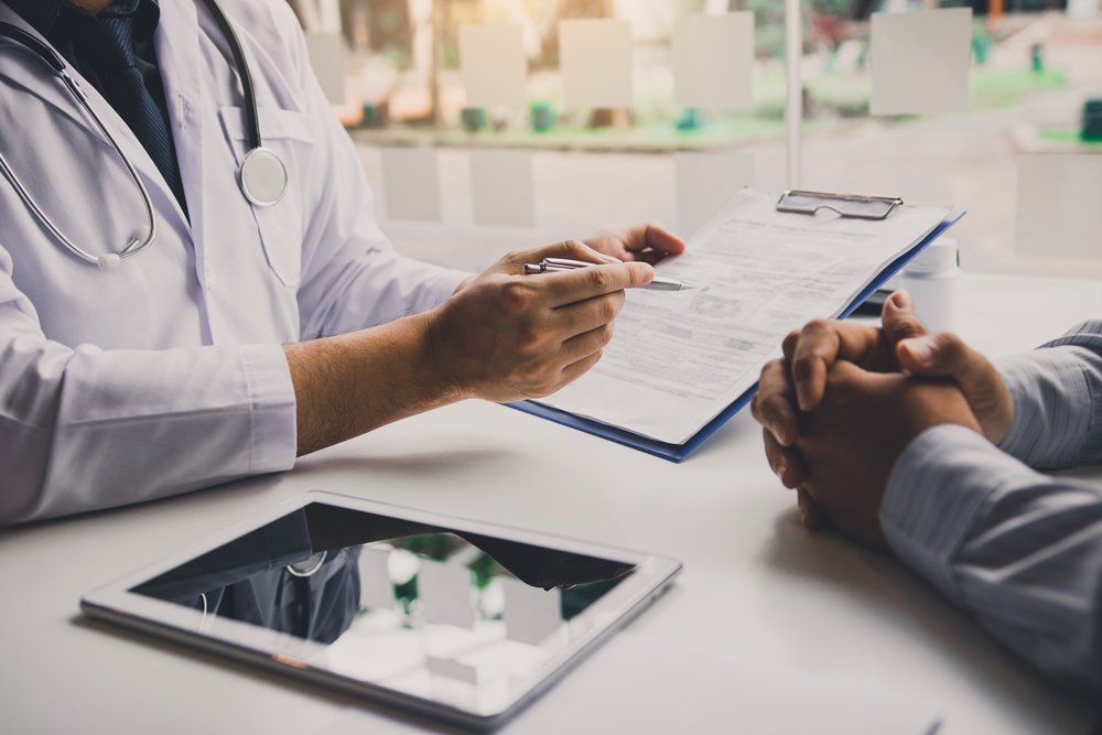 Doctor Is Writing the Appointment Letter to The Patient — Wyomissing, PA — Family Medicine Associates of Wyomissing