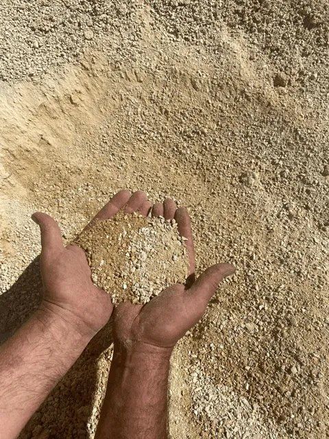 Hands Holding Sand — Building Products in Port Macquarie, NSW