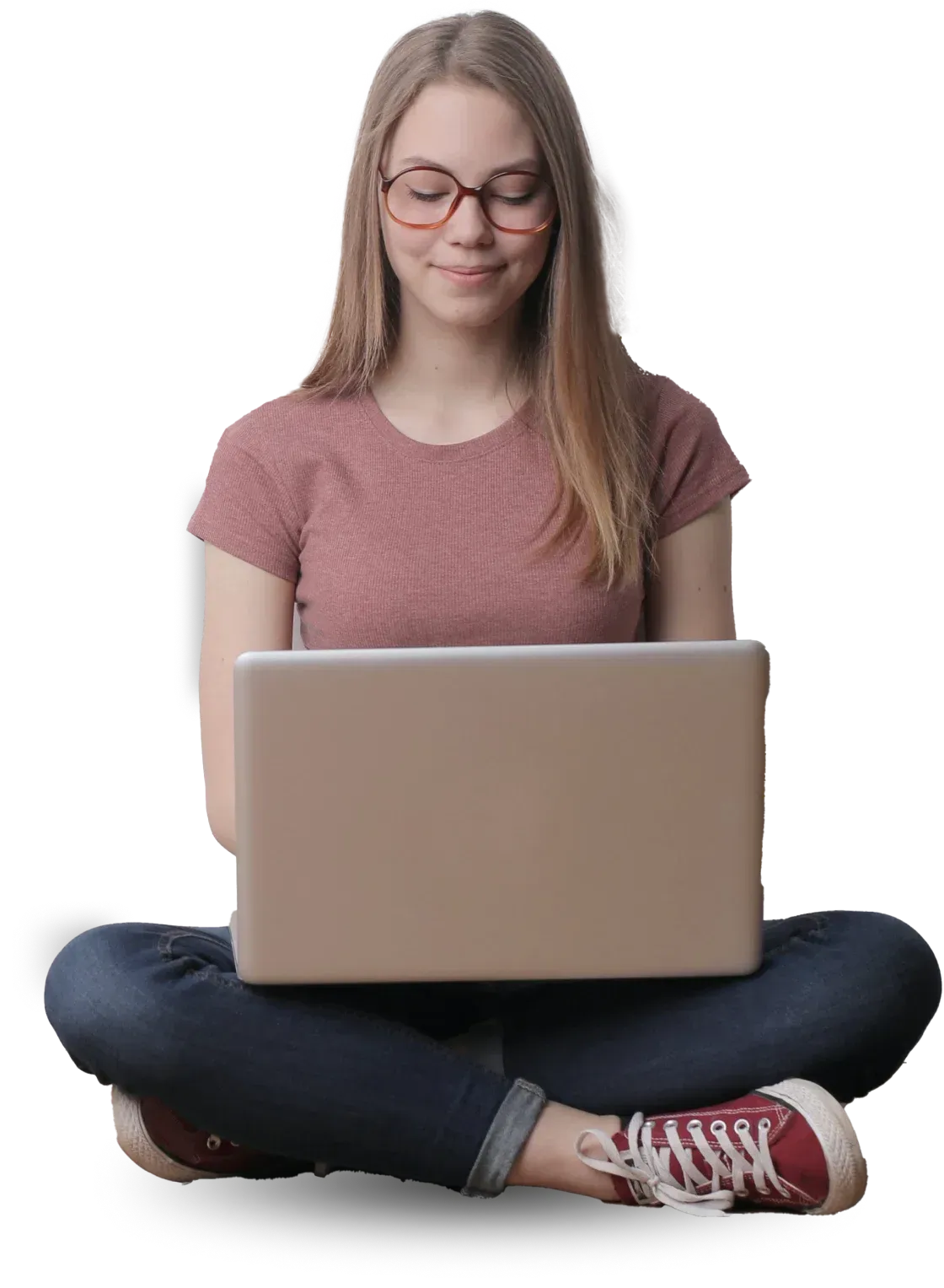 A woman is sitting on the floor using a laptop computer.