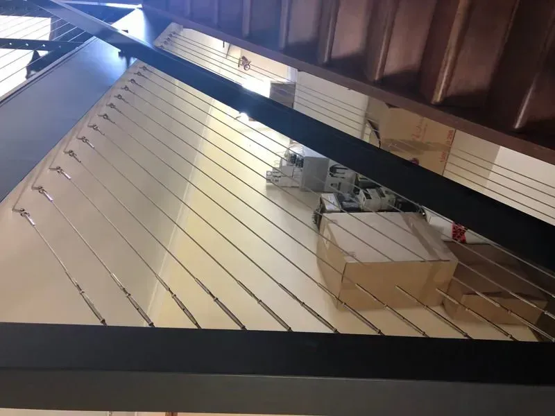 A staircase with a wooden railing and a metal railing — DC Fencing In Wondunna, QLD