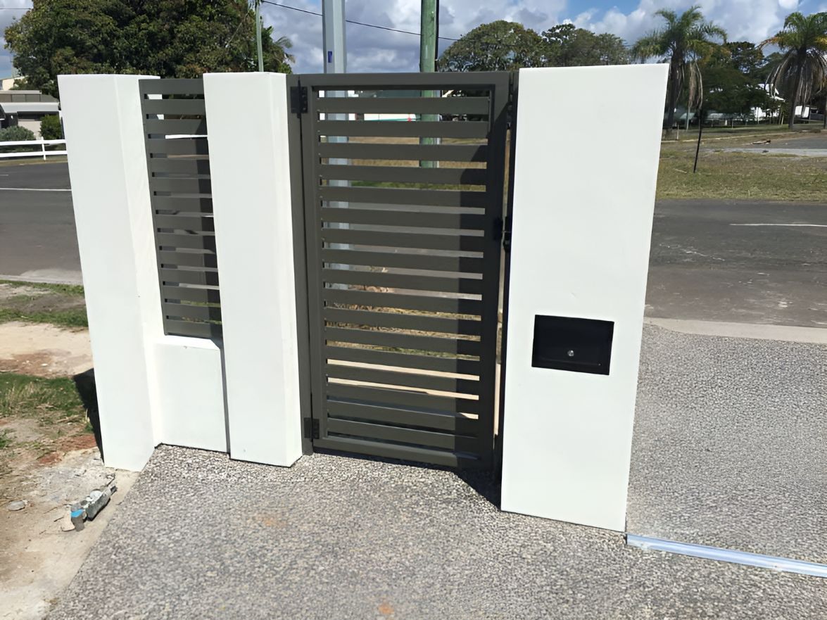 A Fence With a Gate and a Mailbox on It — DC Fencing In Wondunna, QLD