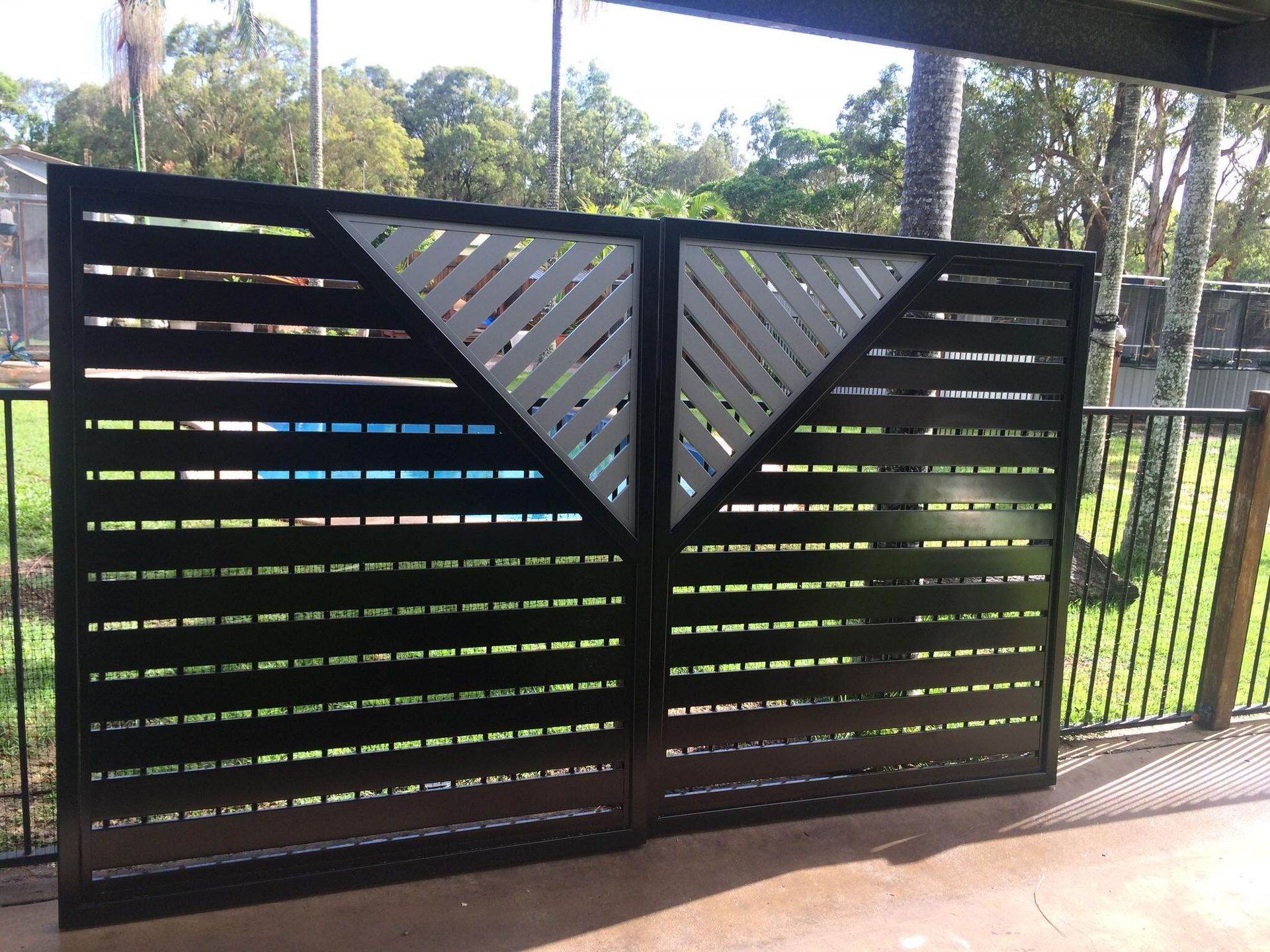 A Wooden Fence With a Geometric Design on It — DC Fencing In Wondunna, QLD