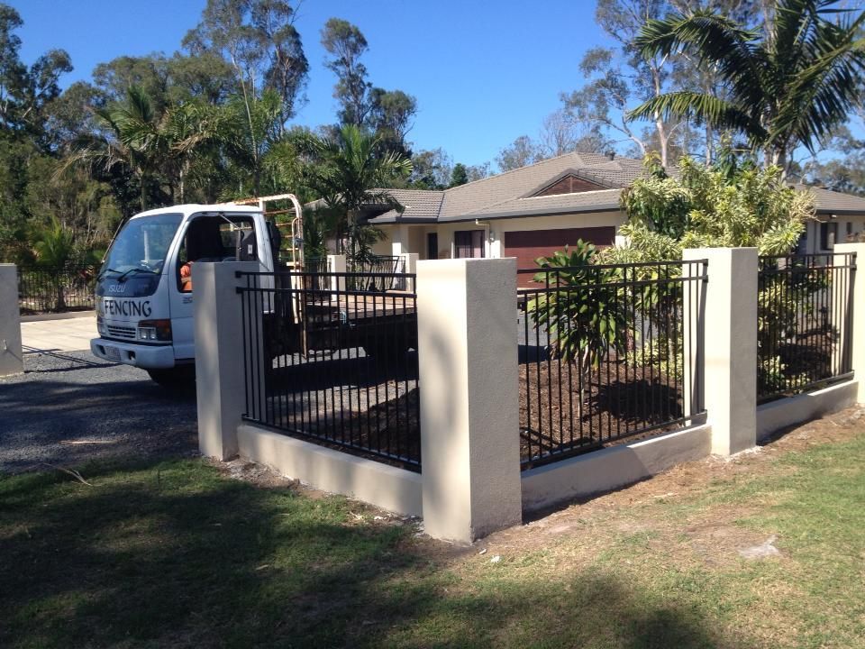 A White Truck is Parked in Front of a House — DC Fencing In Wondunna, QLD