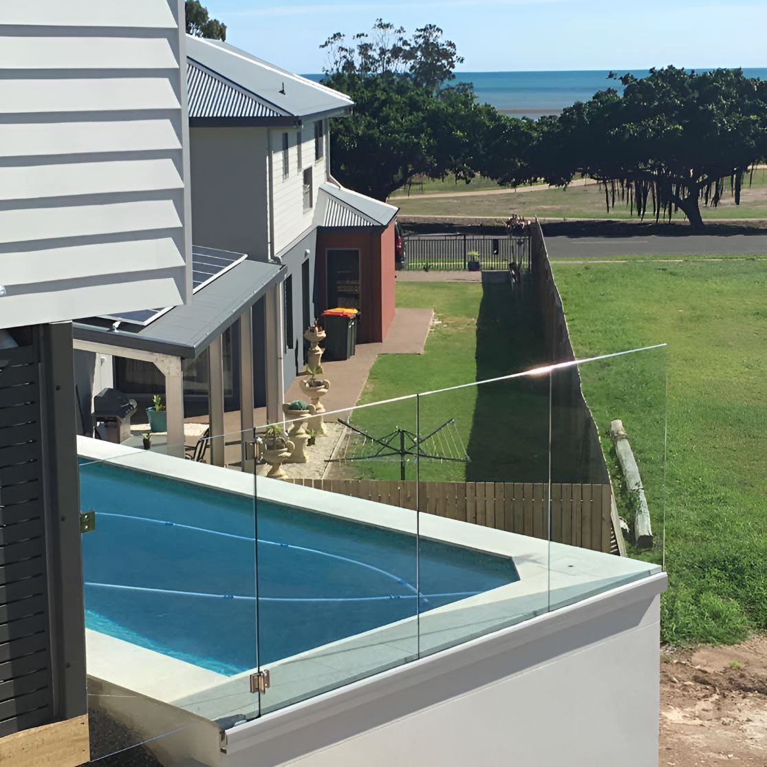 A View of a Swimming Pool From a Balcony Overlooking the Ocean — DC Fencing In Wondunna, QLD