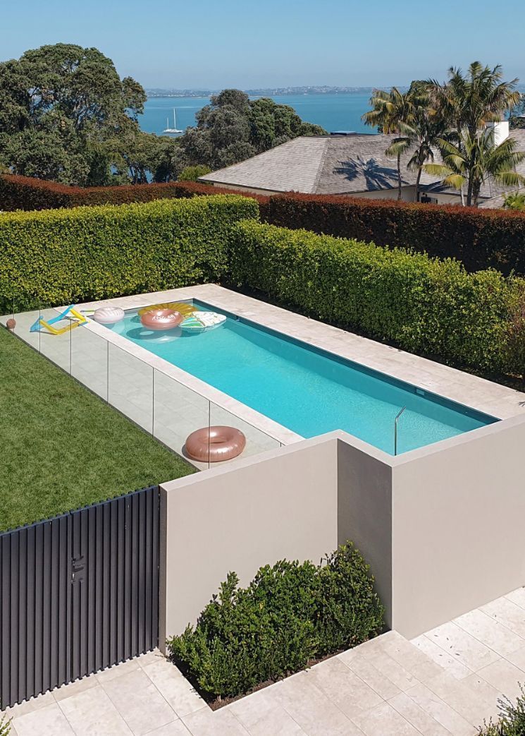 An Aerial View of a Swimming Pool With a Fence and a View of the Ocean — DC Fencing In Wondunna, QLD
