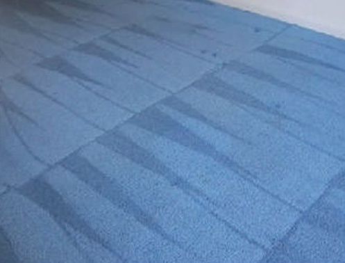 A close up of a blue carpet in a room.