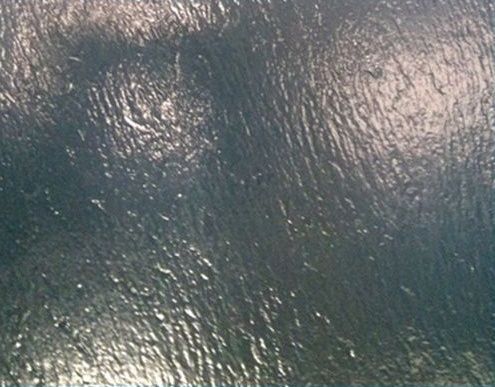 A close up of a blue surface with a shiny texture