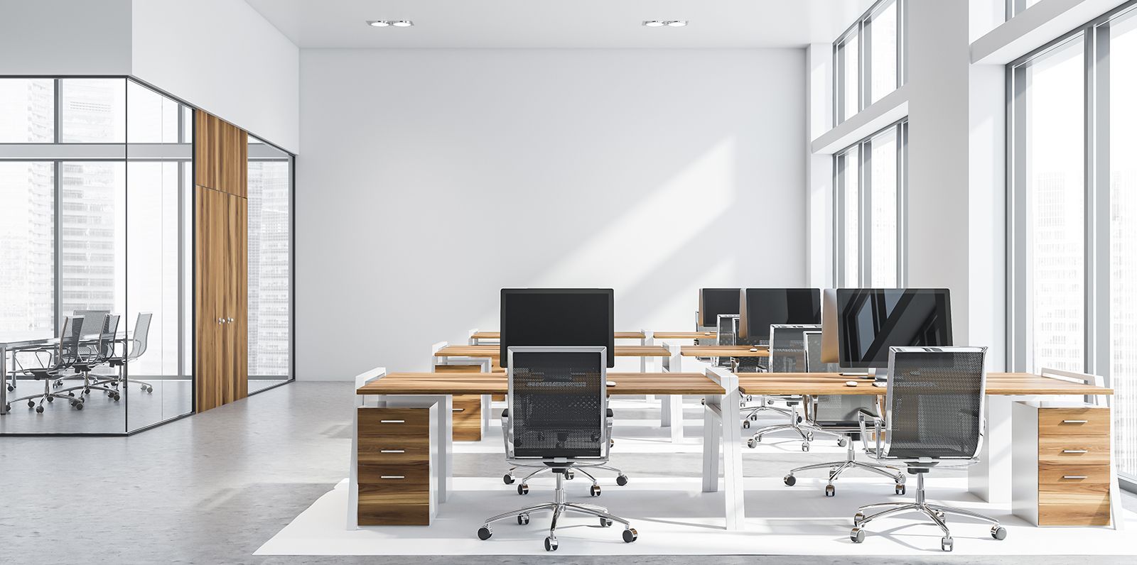 A modern office with a lot of windows and tables and chairs.