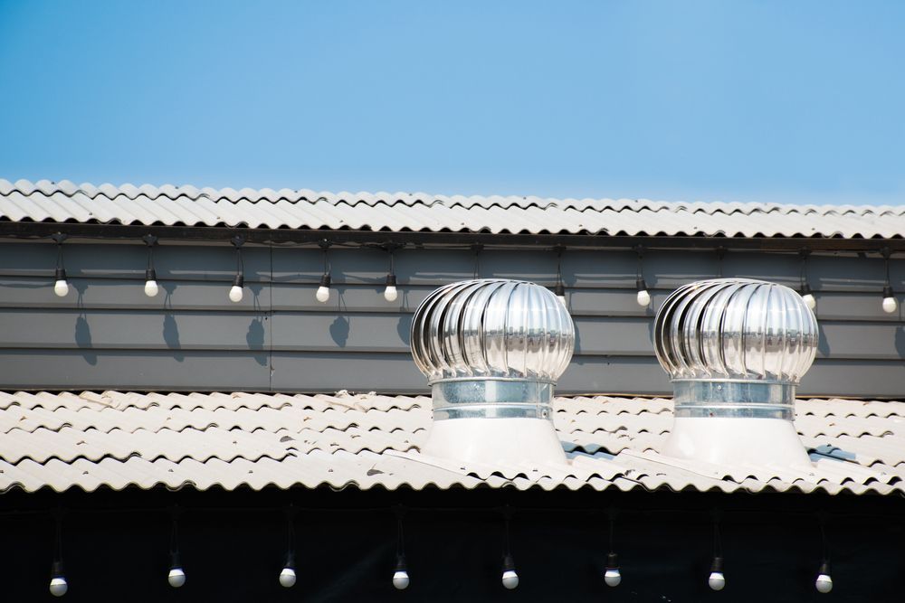 Two Spinning Rooftop Vents on a Corrugated Metal Roof — Boostn Pty Ltd in Tin Can Bay, QLD
