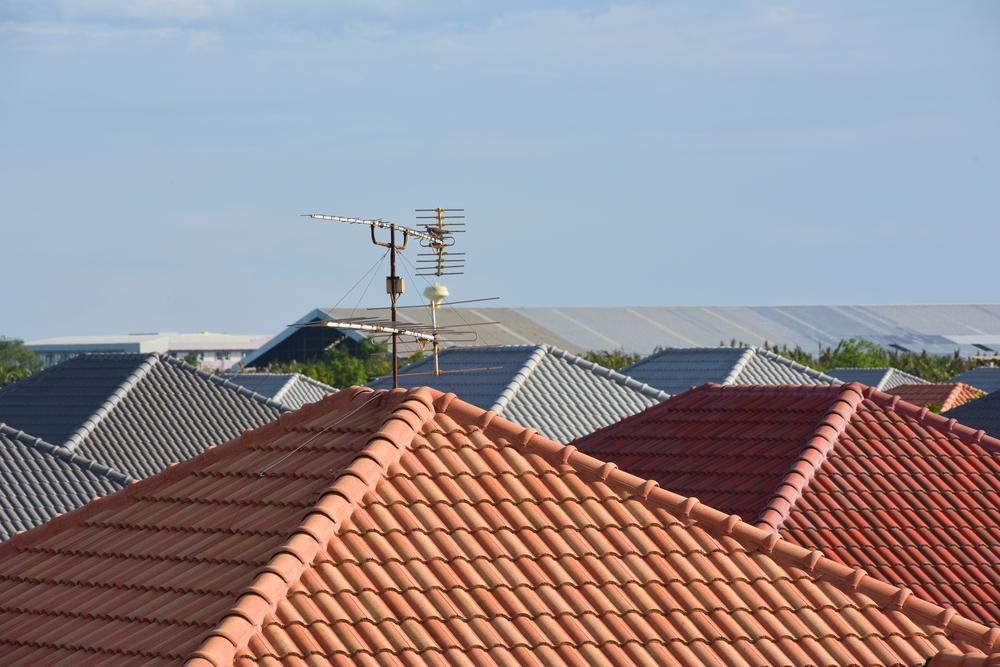 Roofs of Houses With a Television Antenna Against a Blue Sky — Boostn Pty Ltd in Maryborough, QLD