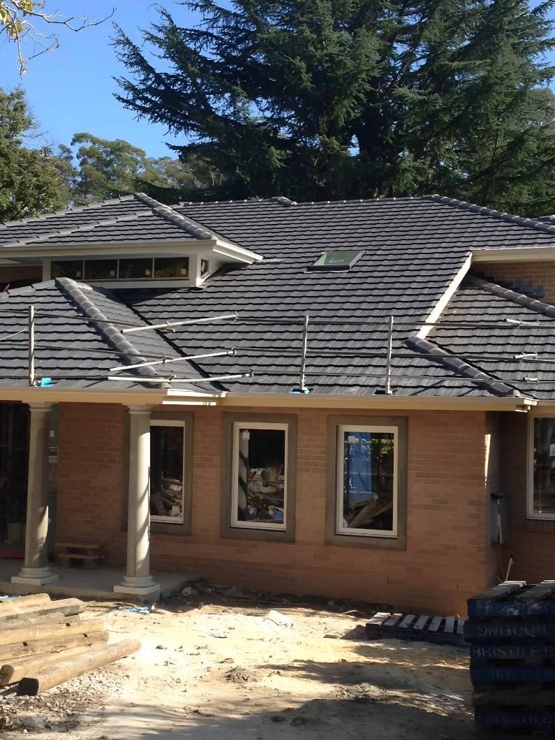 House Under Construction With Dark Gray Roof Tiles — Boostn Pty Ltd in Glastonbury, QLD