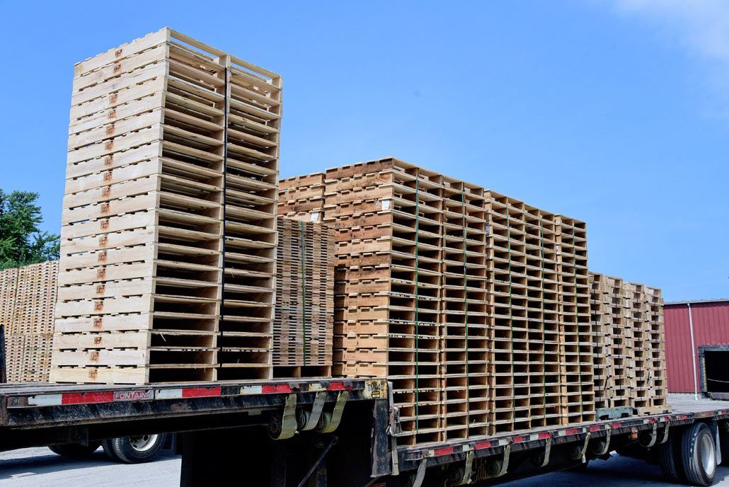 Long Flatbed Trailer Stacked With Wood Pallets