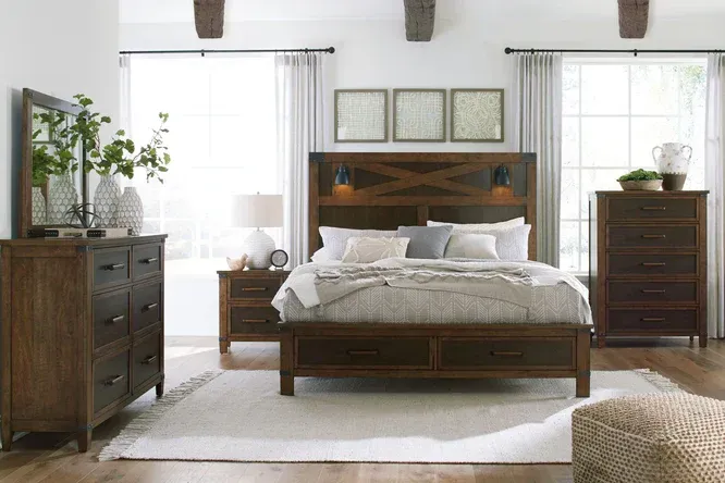 Bedroom with wood furniture: dresser, bed with headboard, nightstand, and chest.