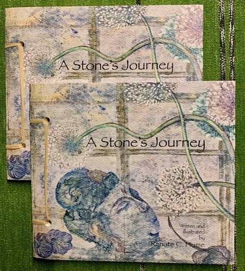 two copies of The Stone's Journey book on green background