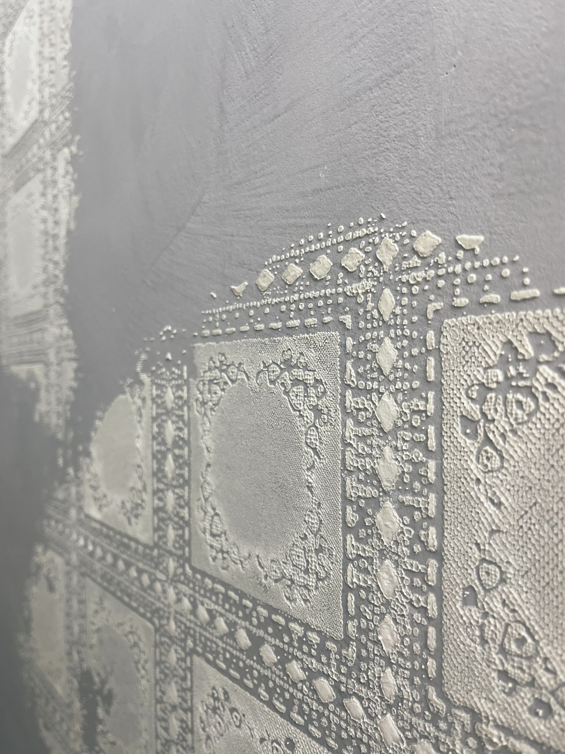 Betonciré Wand Betonlook in hellgrau mit dekorierenden Ornamenten