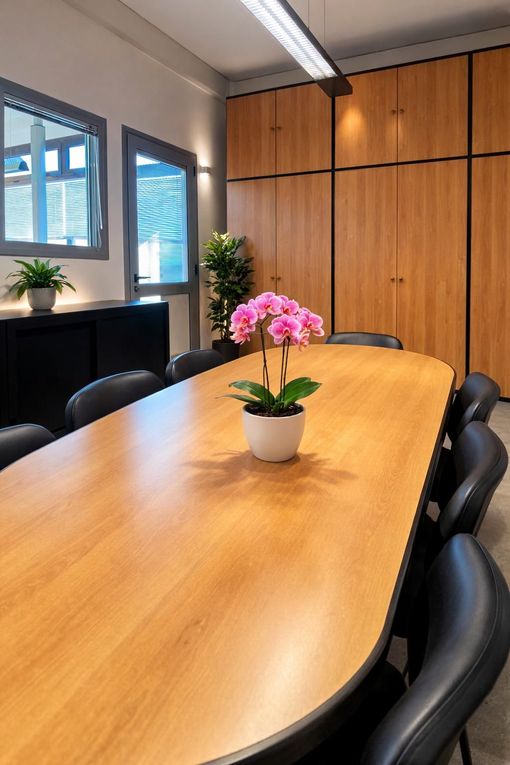 Yellow truck-mounted pile driver machine operating on a construction site with a forest background under a cloudy sky.