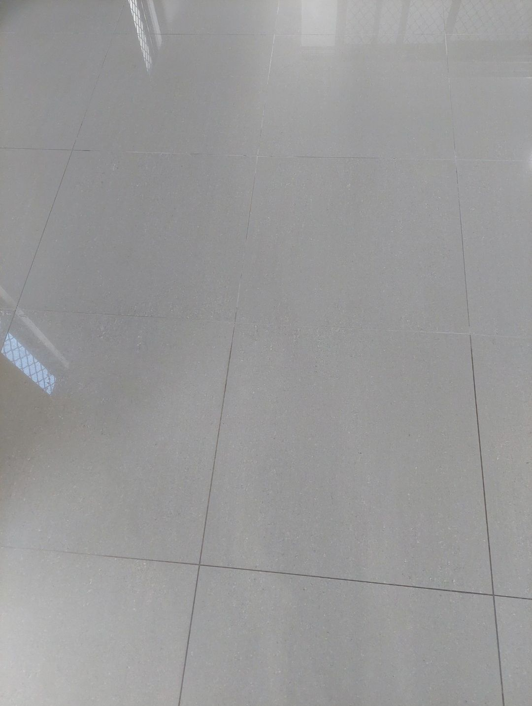 Man With Gloves Removing Grout Between Tiles — Premium Carpet Cleaning In Trinity Park, QLD