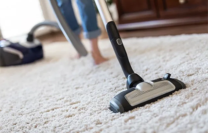 Woman Using A Vacuum Cleaner While Cleaning Carpet — Premium Carpet Cleaning In Trinity Park, QLD