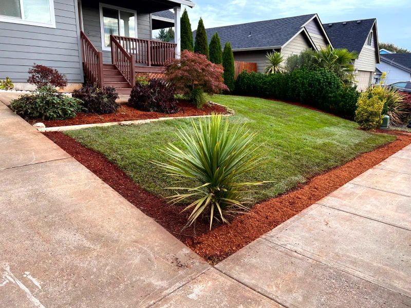 A house with a lush green lawn in front of it