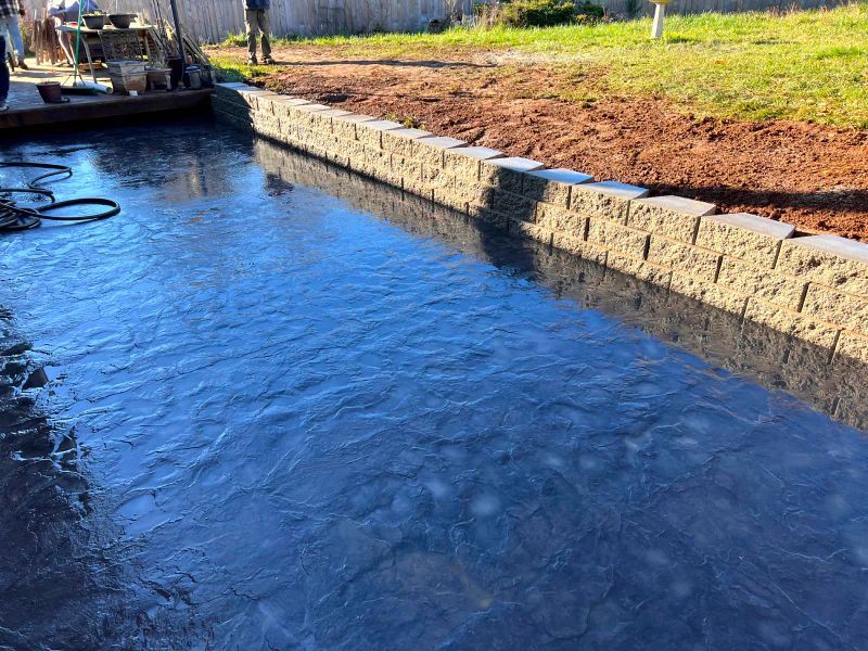 A concrete wall is being built next to a body of water.