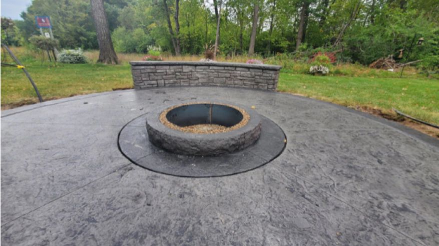 There is a fire pit in the middle of the patio.