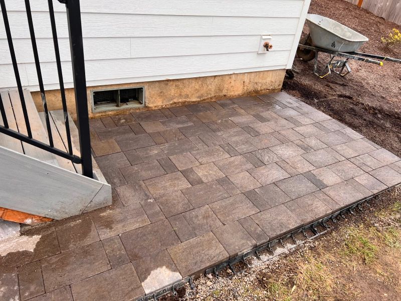 A brick walkway is being built in front of a house.