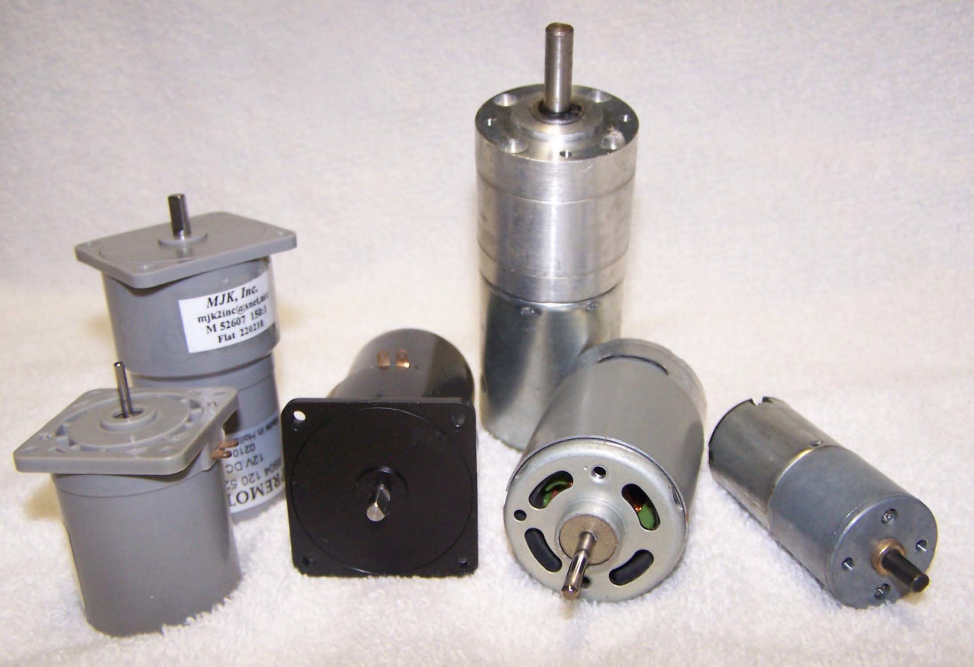 A white motor is sitting on the floor in a warehouse.