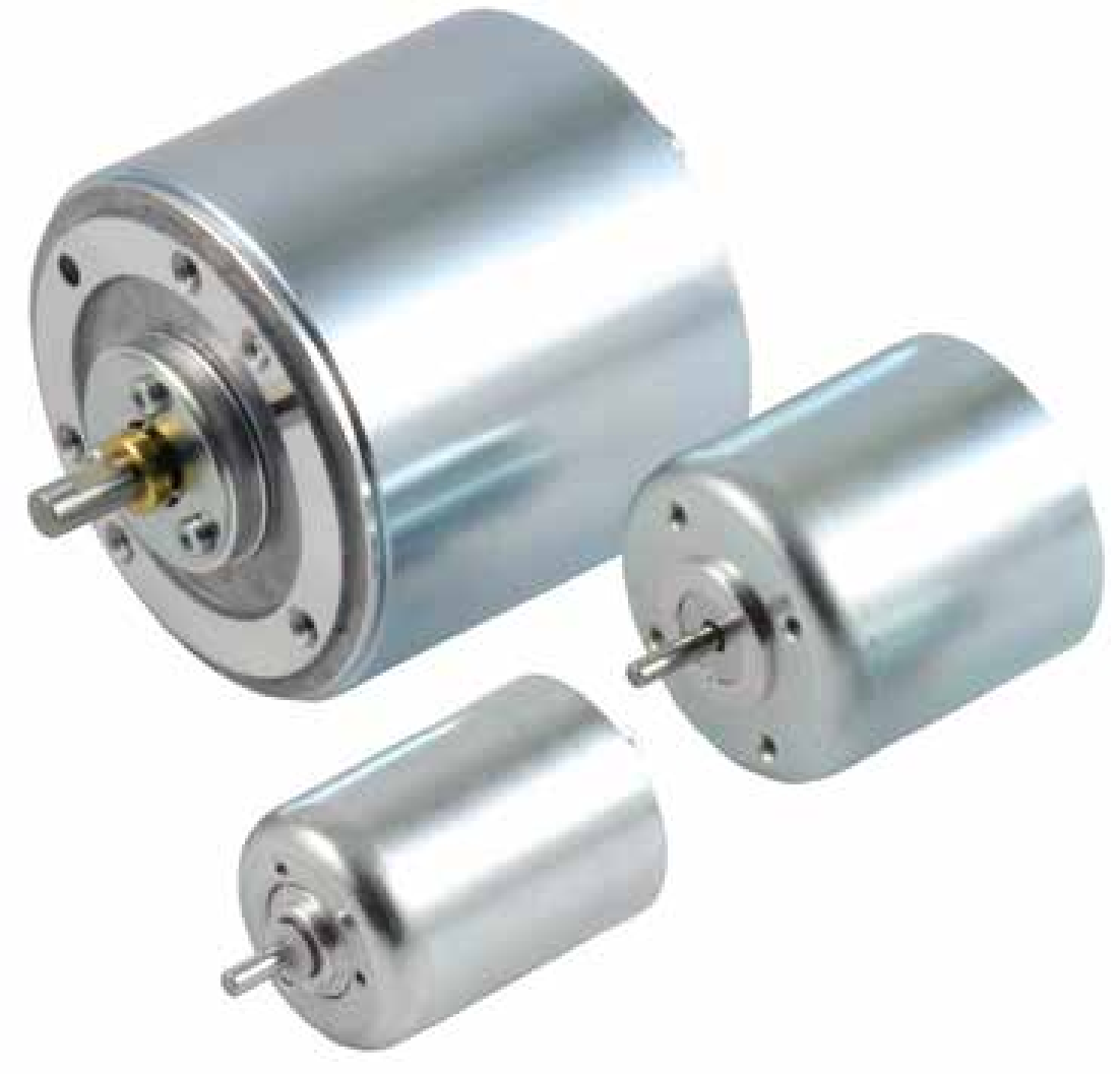 A large electric motor is sitting on a wooden table.