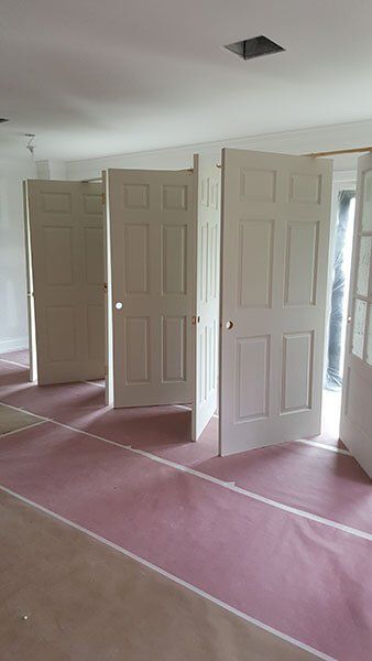 Interior painting by local painting contractors, featuring doors and walls with a pristine finish.