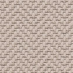 A close up of a beige carpet with a pattern on it.