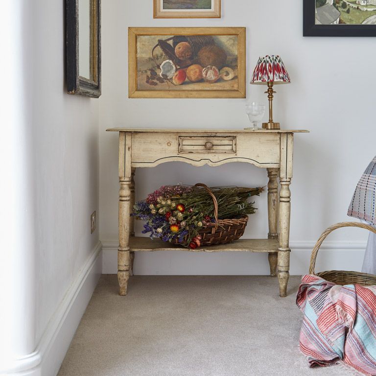 A table with a basket of flowers on it