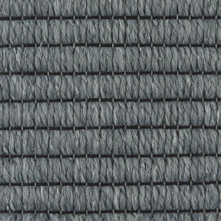 A close up of a gray carpet with a checkered pattern.