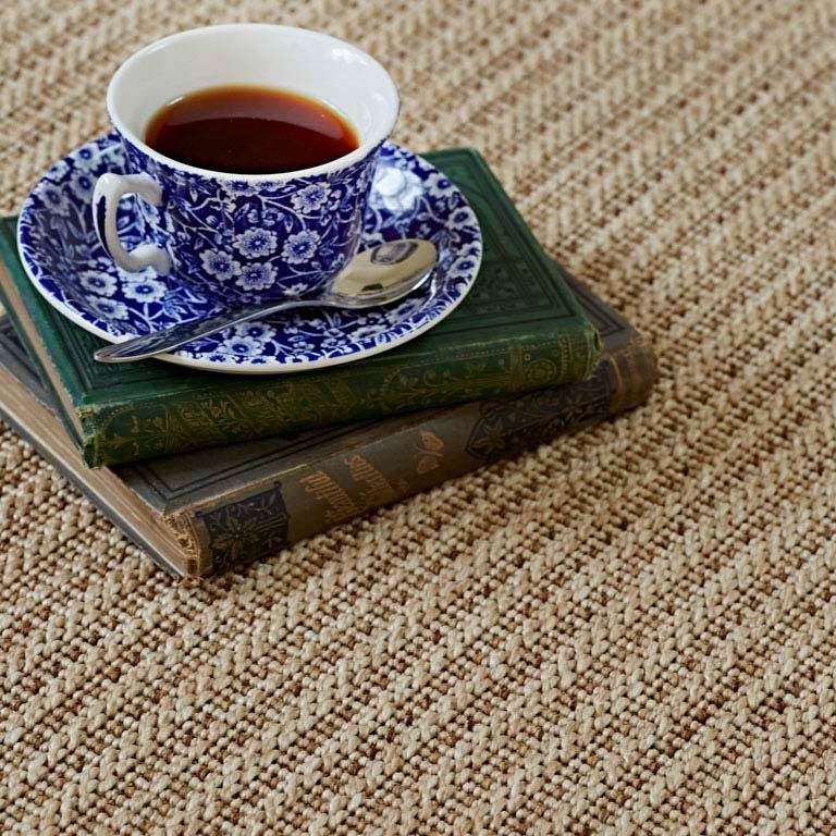 A cup of tea is sitting on top of a stack of books.