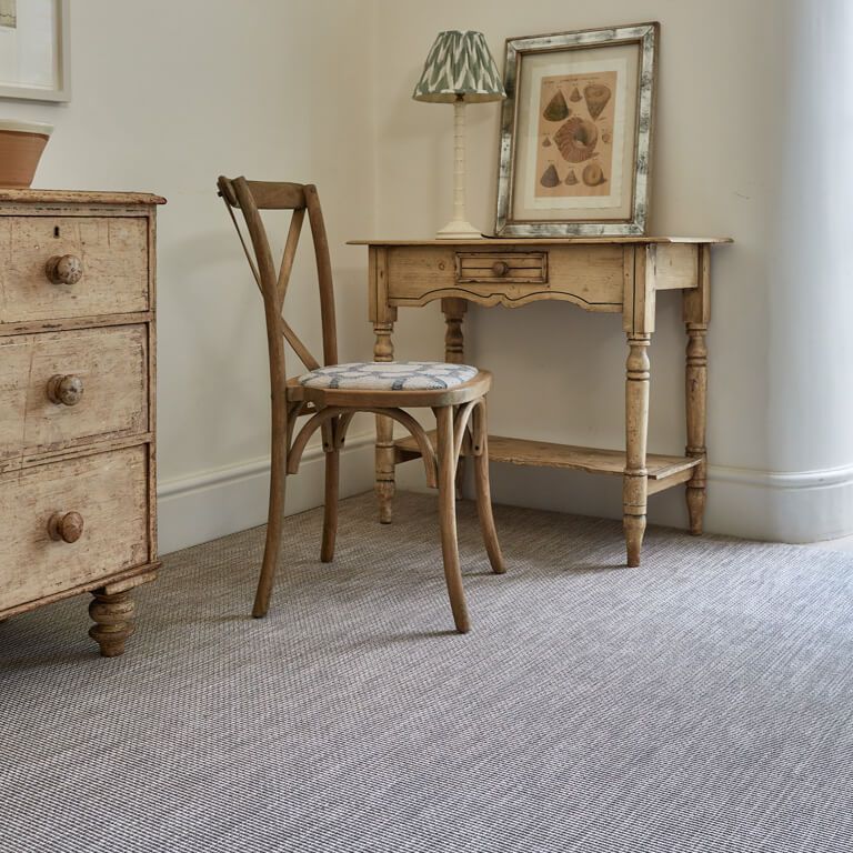 A chair sits in front of a desk in a room