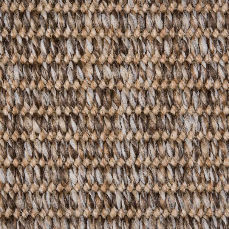 A close up of a rug with a knitted pattern