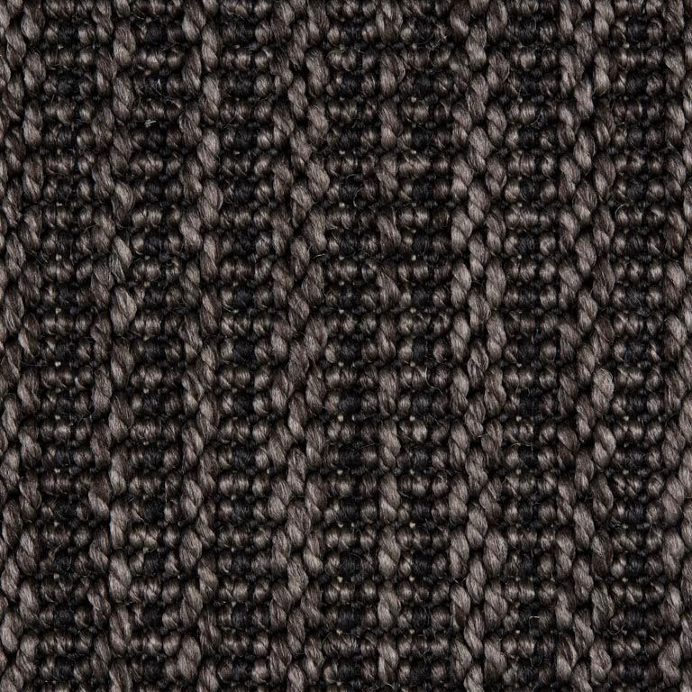 A close up of a black and grey carpet texture.