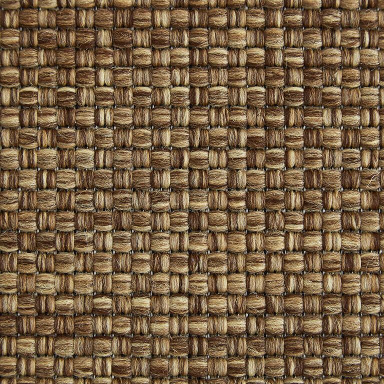 A close up of a brown fabric with a checkered pattern