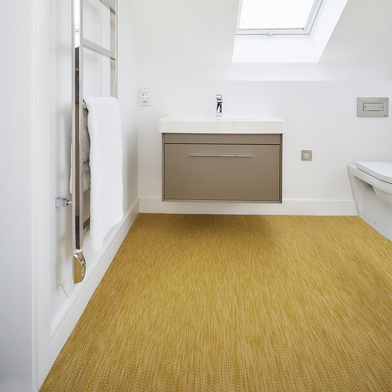 A bathroom with a sink , toilet and skylight