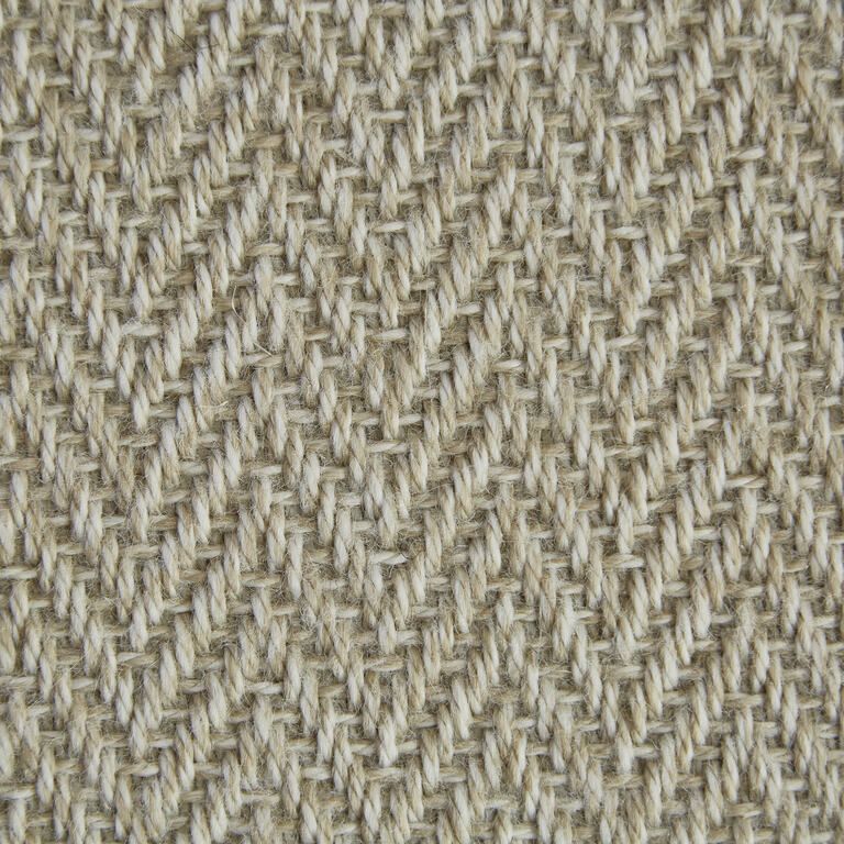 A close up of a knitted fabric with a herringbone pattern.