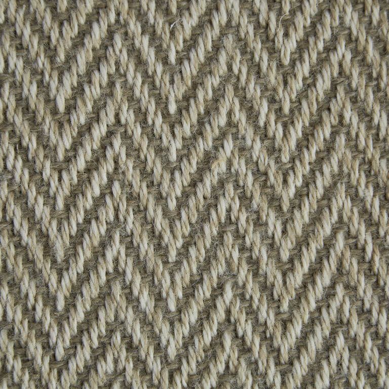 A close up of a fabric with a herringbone pattern.