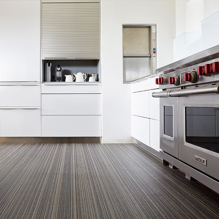 A kitchen with stainless steel appliances and white cabinets