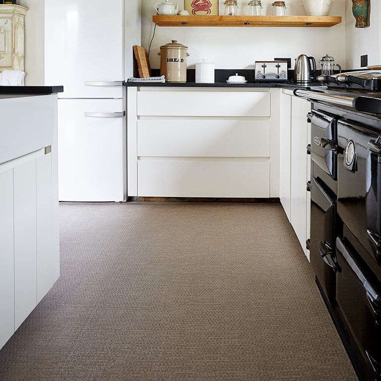 A kitchen with white cabinets and a black stove