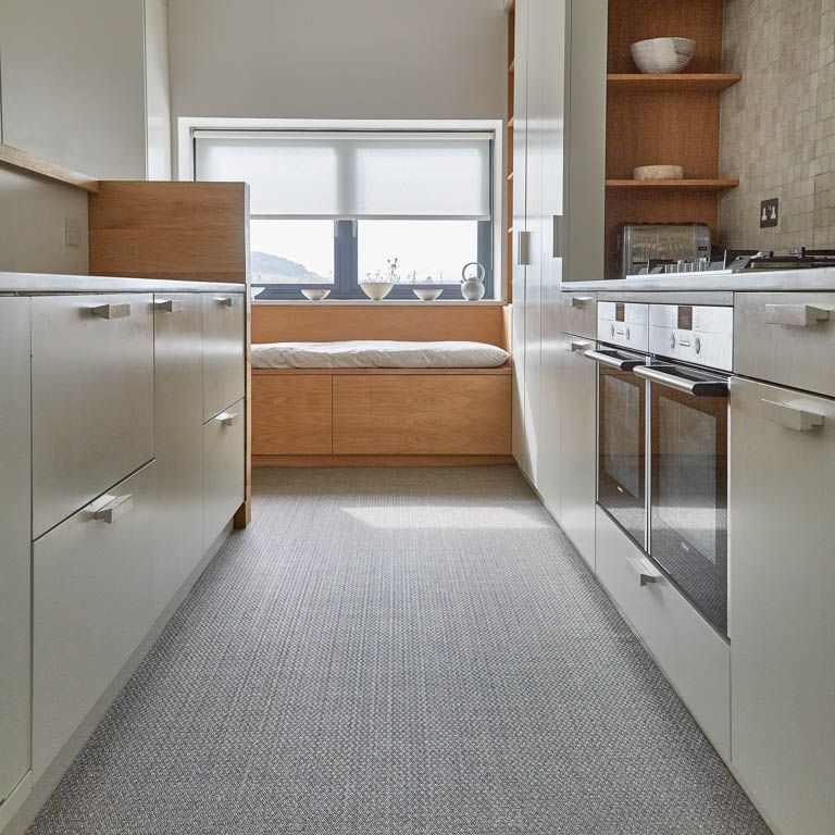 A kitchen with white cabinets and stainless steel appliances