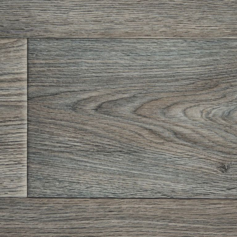 A close up of a piece of vinyl flooring that looks like wood.