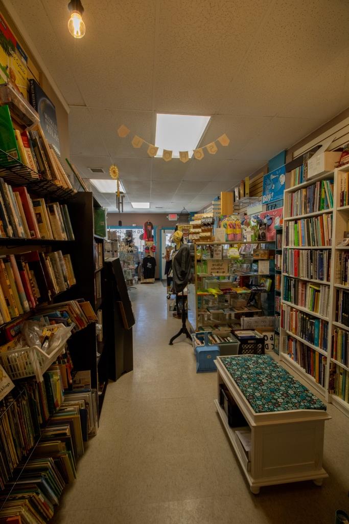 A bookstore with a table in the middle of it.