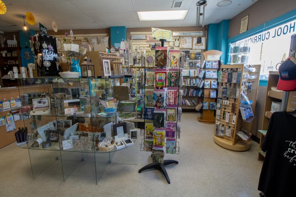 A display of cards in a store with a sign that says 'greeting cards' on it.