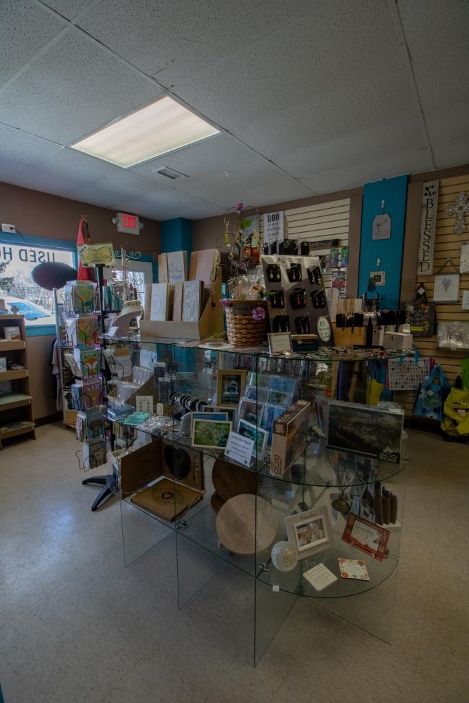A store filled with lots of items including a glass table.