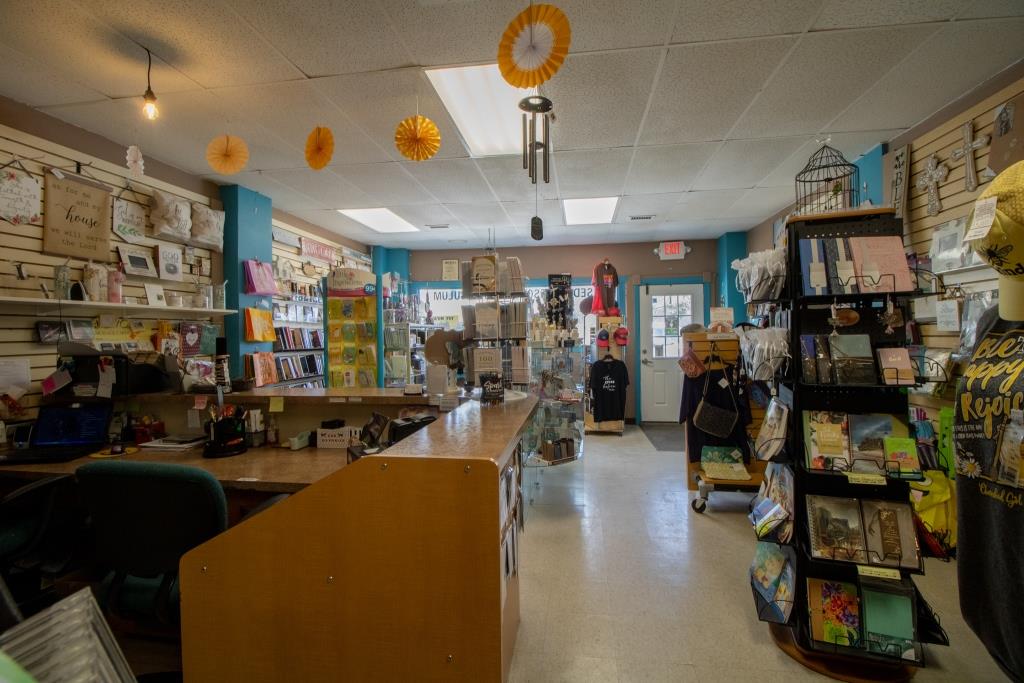A store with a wind chime hanging from the ceiling.