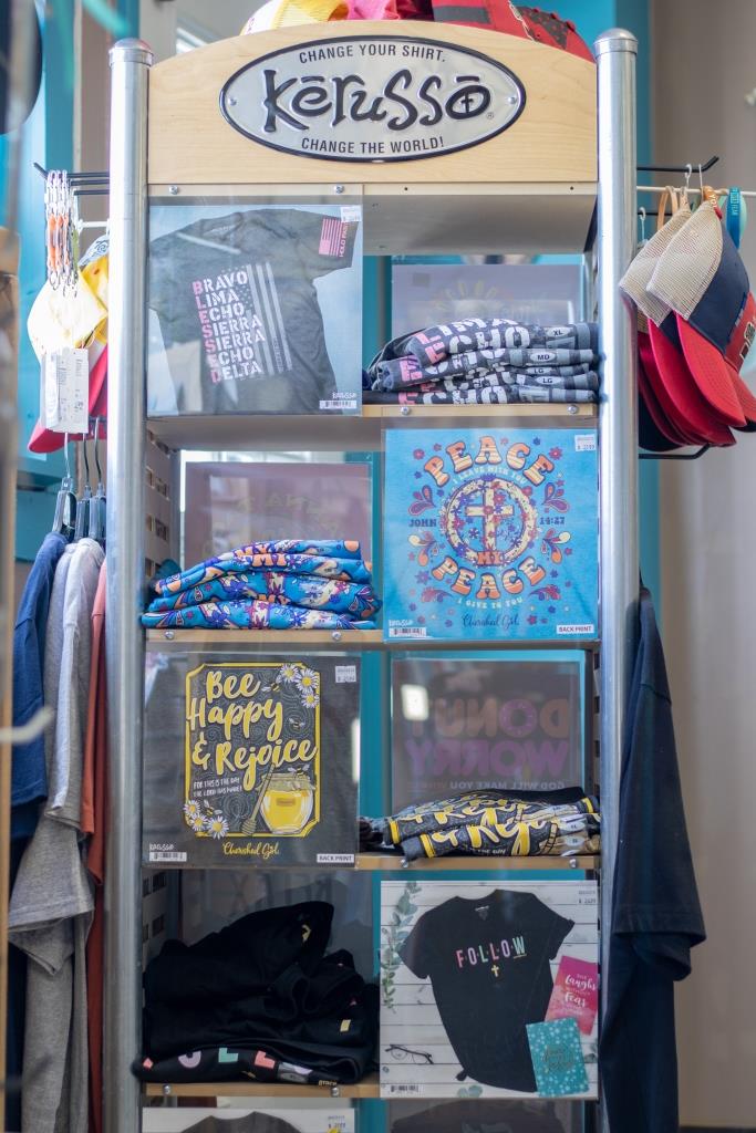 A display of Kerusso shirts and hats in a store.