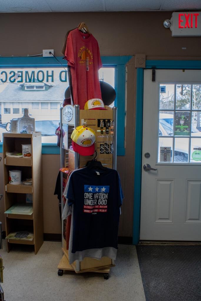 A store with a shirt hanging that says 'One Nation Under God.'